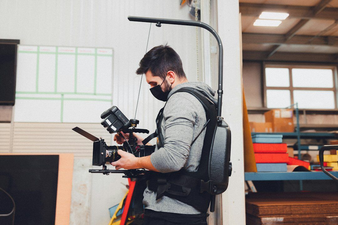 Camera operator filming inside a television studio